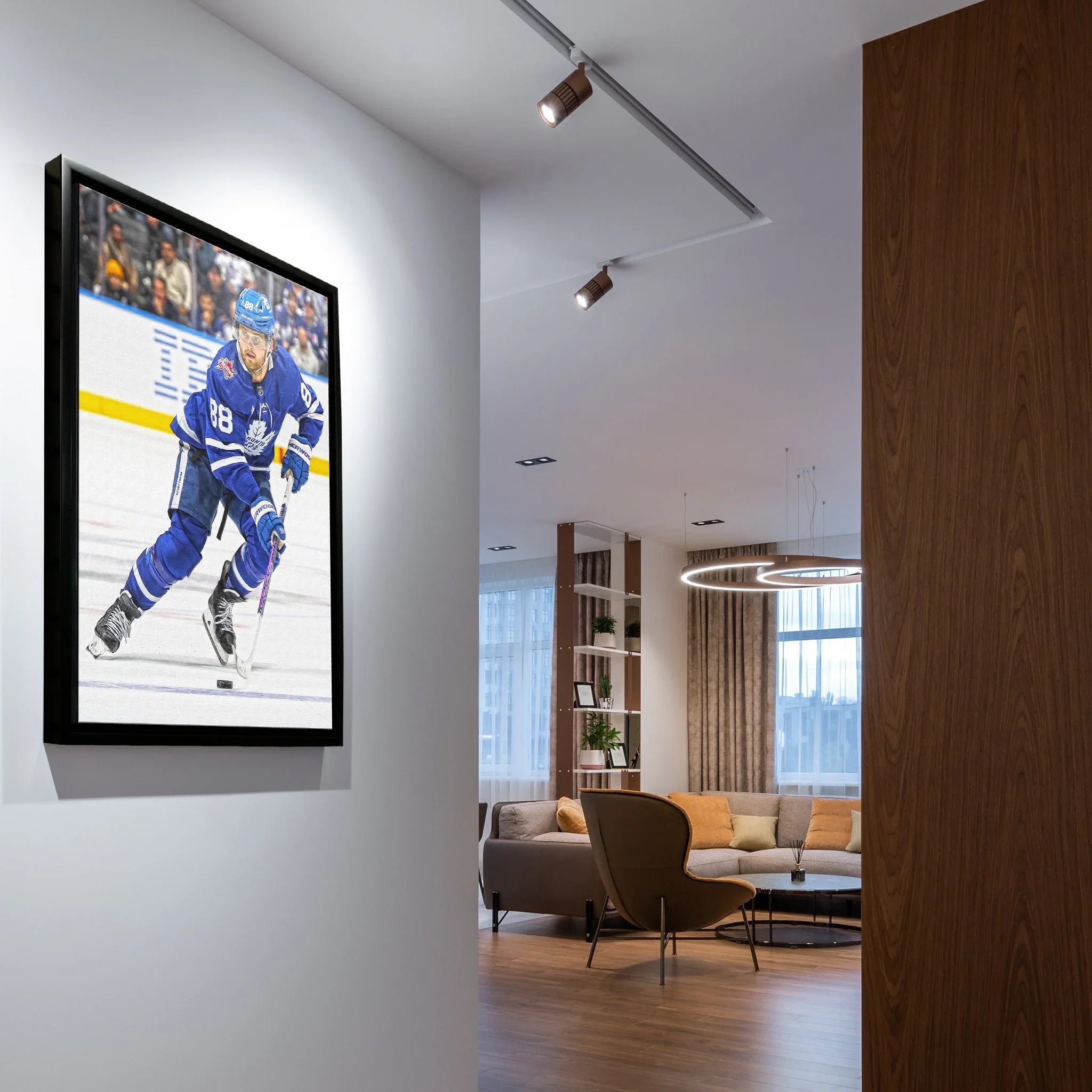 Modern living room with framed hockey player art on white wall, contemporary decor