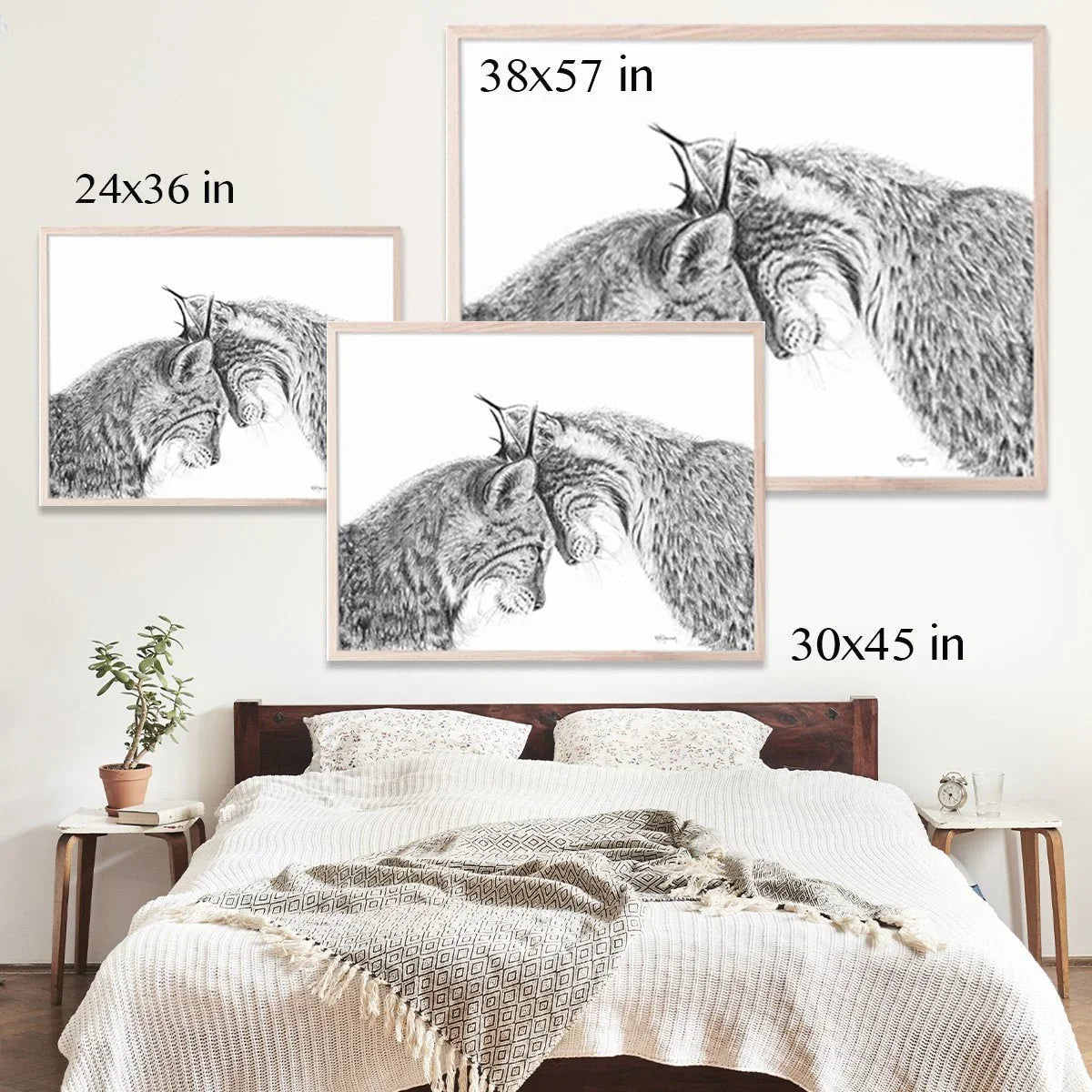 Framed wolf cuddles wall art above bed, shown in 24x36, 30x45, and 38x57 inch sizes.