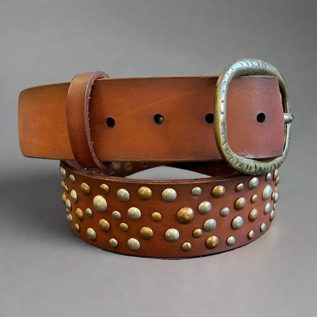 Women's full-grain brown leather belt with oval buckle and metal studs on gray background