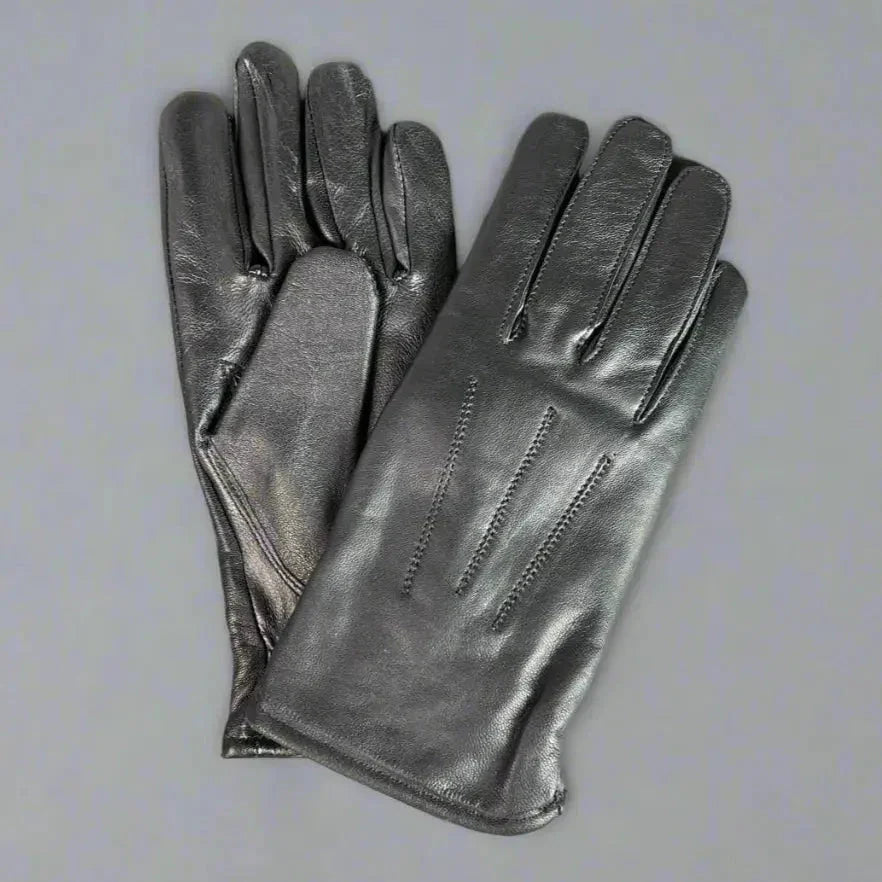 Women’s genuine black leather gloves with stitched detail on grey background