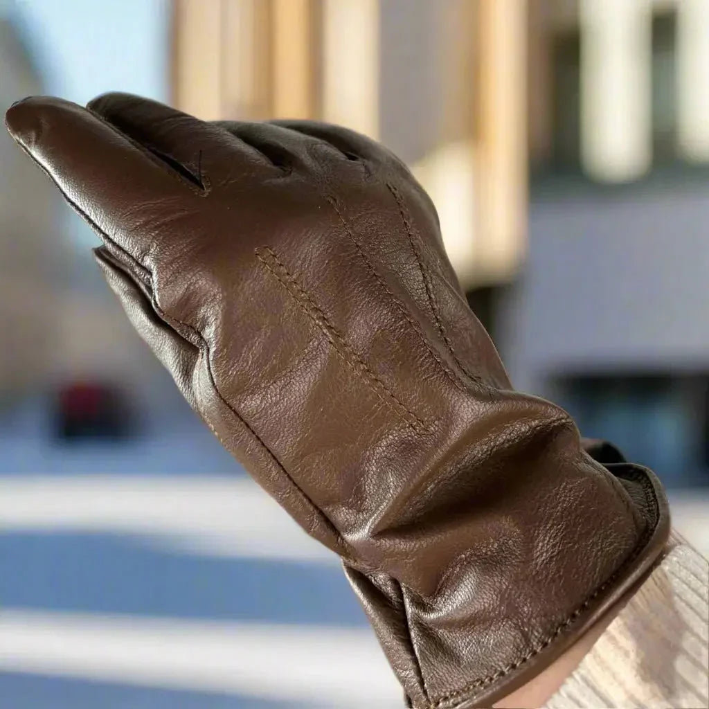 Brown women's leather glove with fur lining shown outdoors