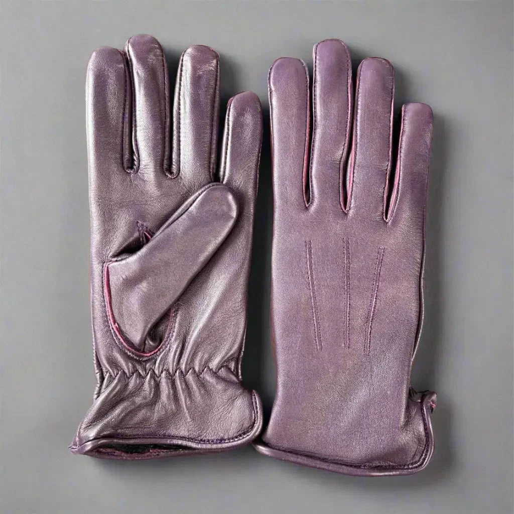 Purple women's leather gloves with fur lining on a gray background