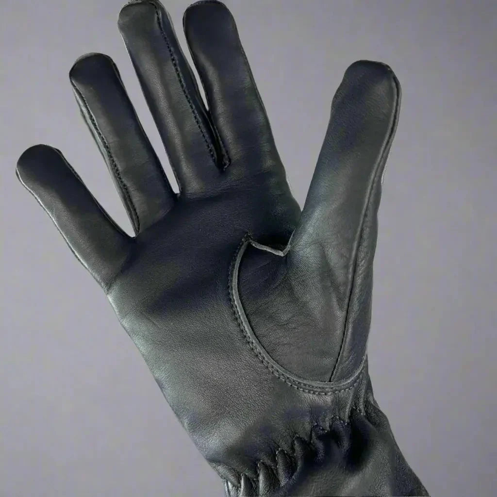 Black women's leather glove with fur lining on a neutral background