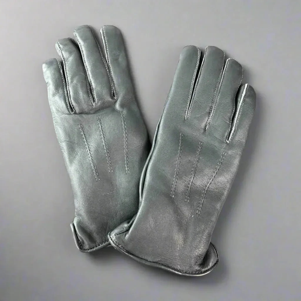 Women's grey leather gloves with stitching, fur lining, on a plain background