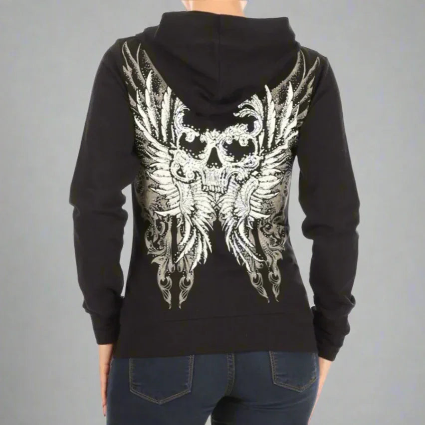 Black hoodie with silver skull and wing graphic on back, worn by woman in jeans