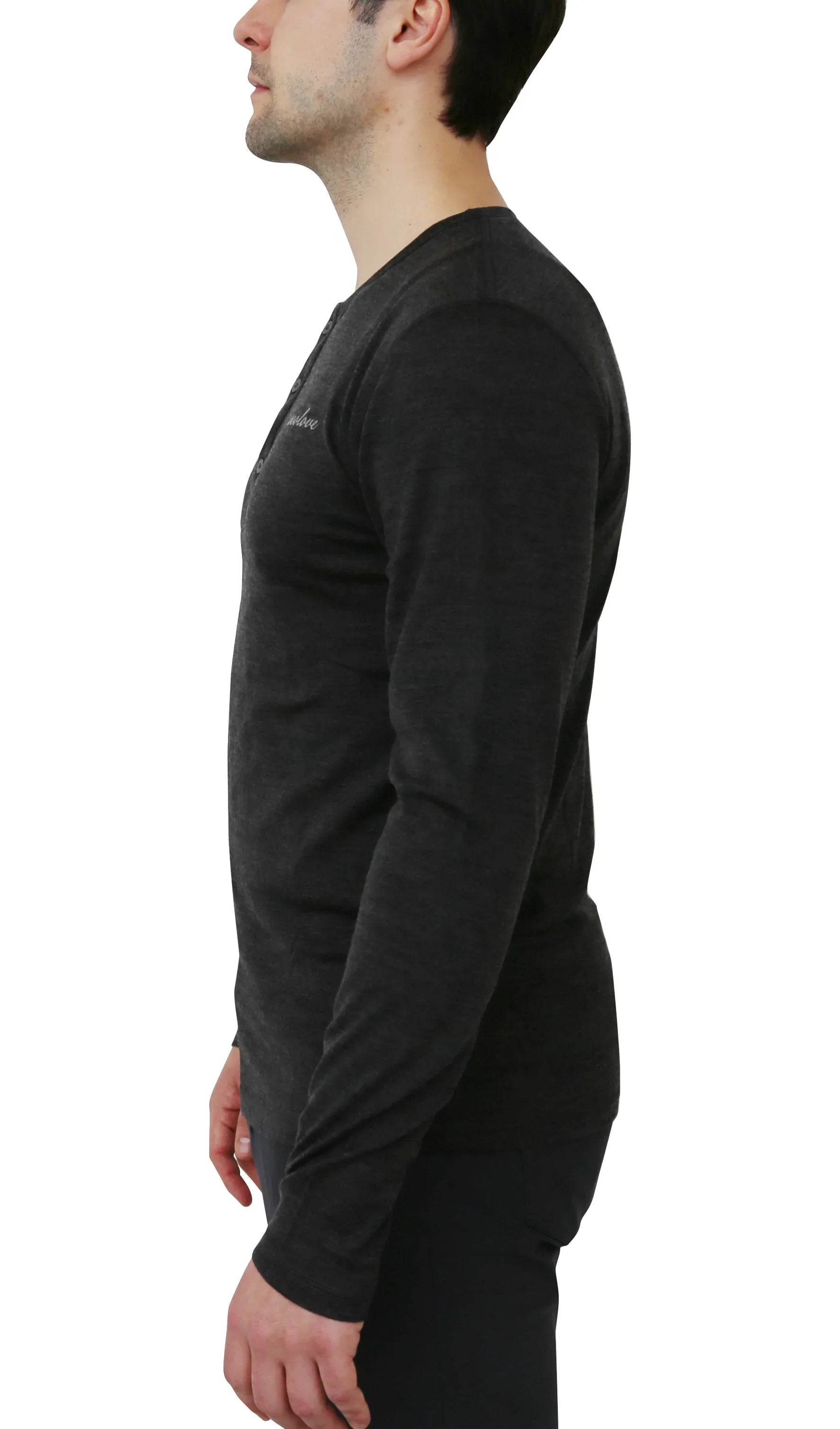 Man wearing black merino wool long sleeve Henley shirt, side view on white background