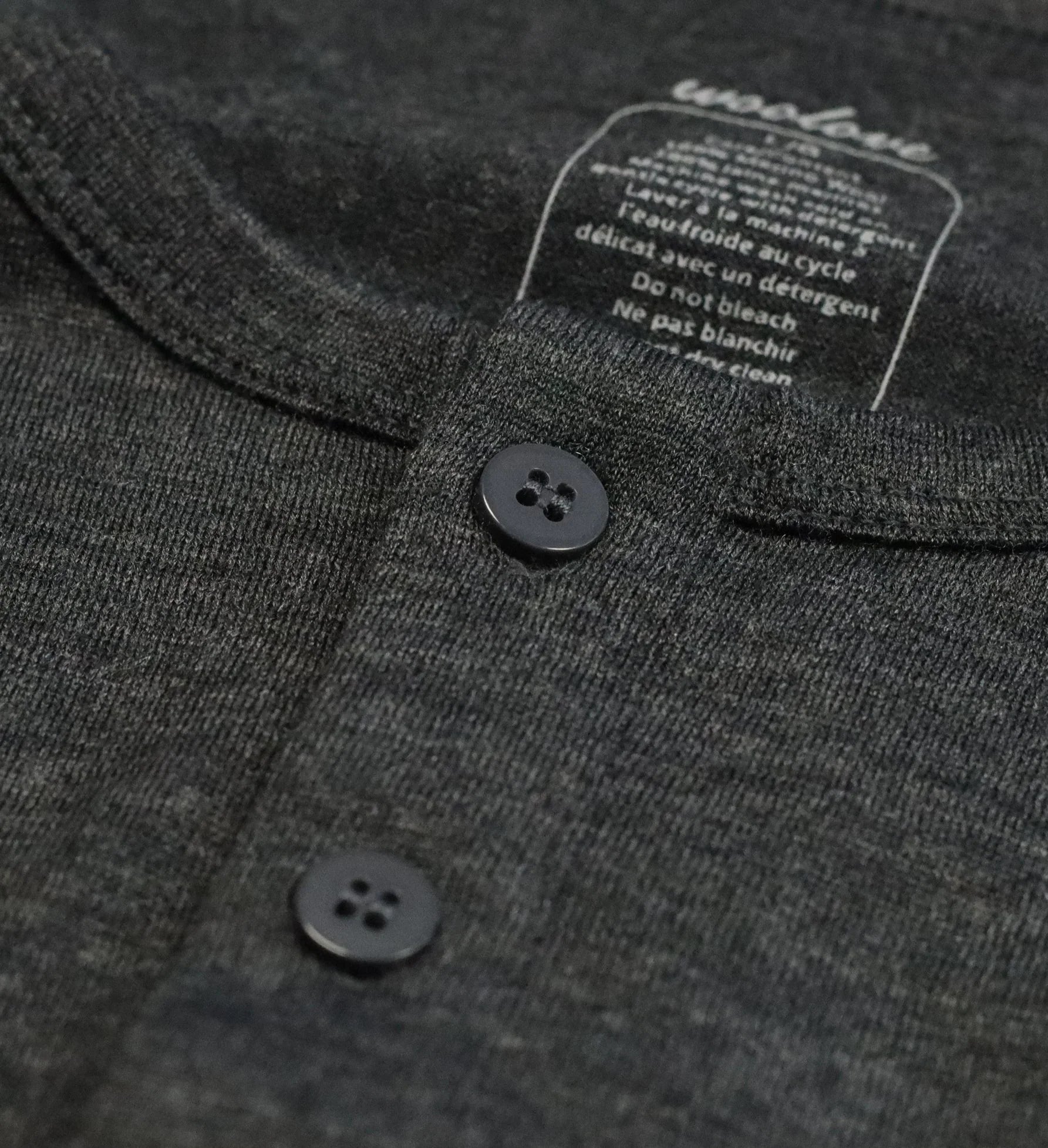 Close-up of dark grey men’s merino wool long sleeve Henley shirt with buttons