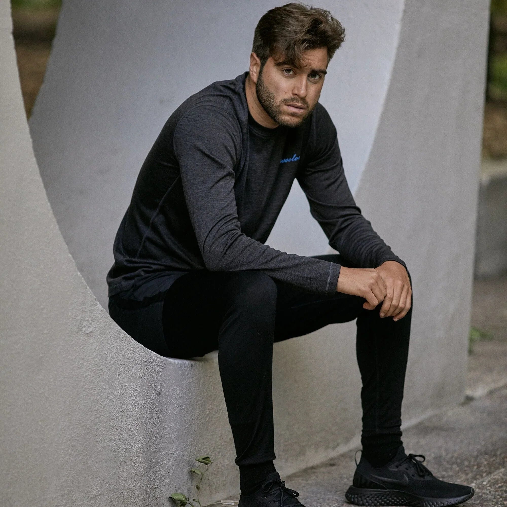 Man wearing black merino wool long underwear base layer leggings outdoors