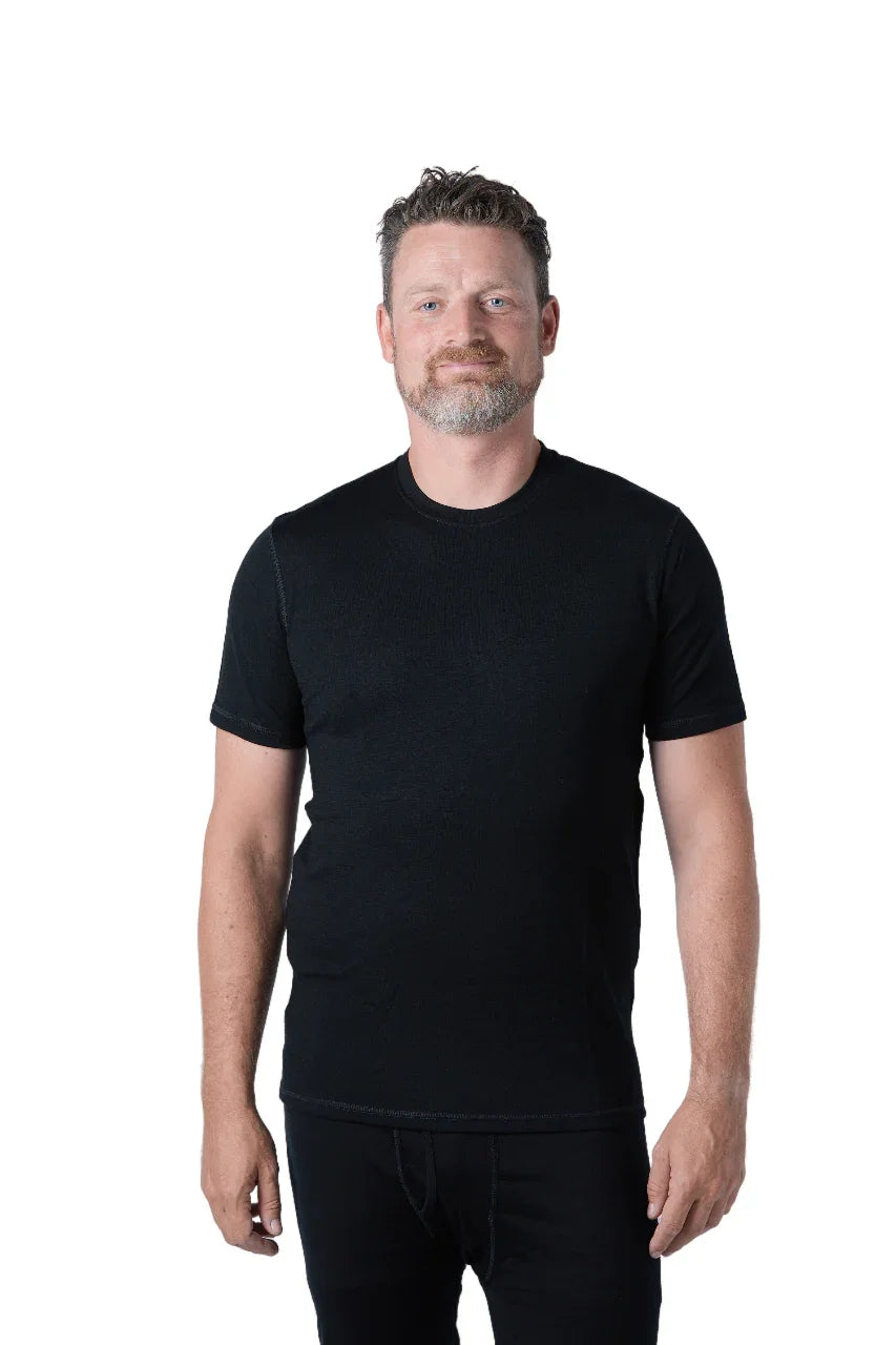Man wearing black merino wool t-shirt against white background