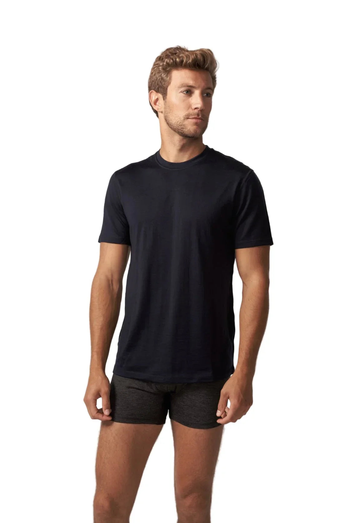 Man wearing black merino wool short sleeve t-shirt on white background