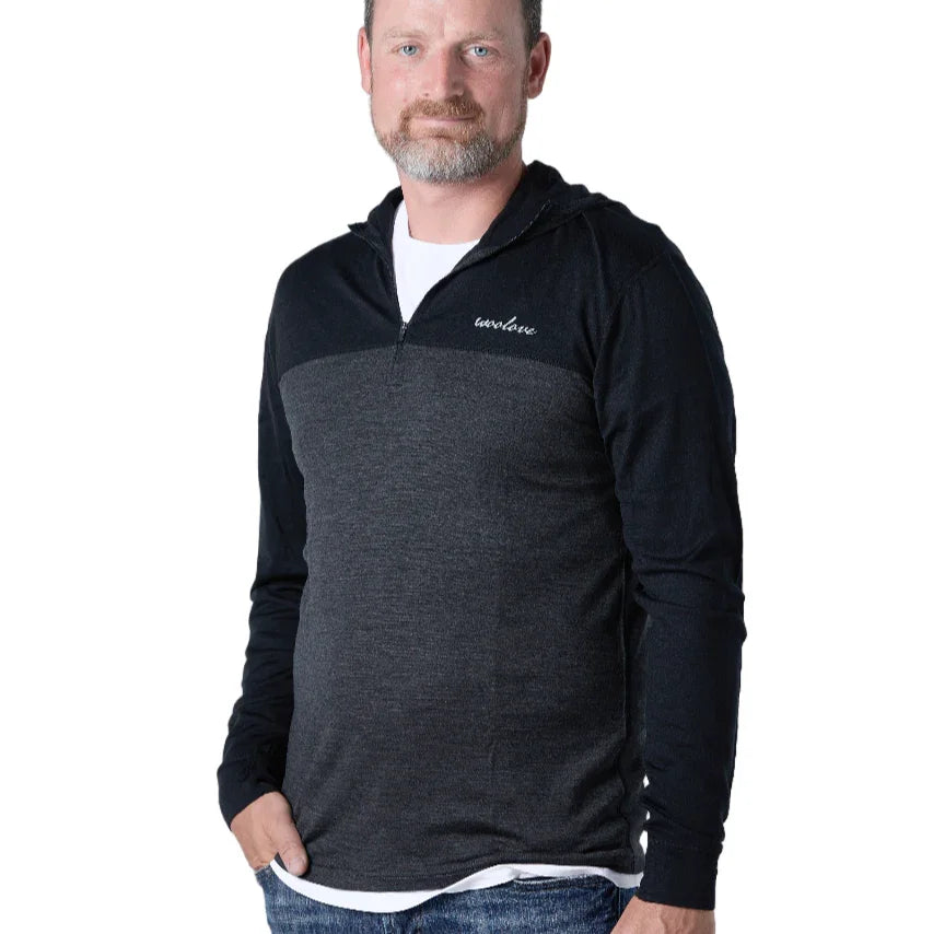 Man wearing Woolove men's merino wool quarter zip hoodie in dark grey and black