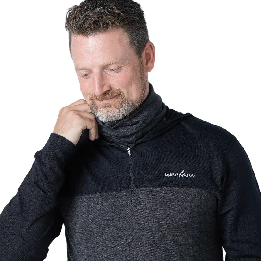 Man wearing dark Woolove merino wool pullover with zip neck and logo on chest