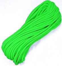Bright green paracord rope coiled neatly on a white background