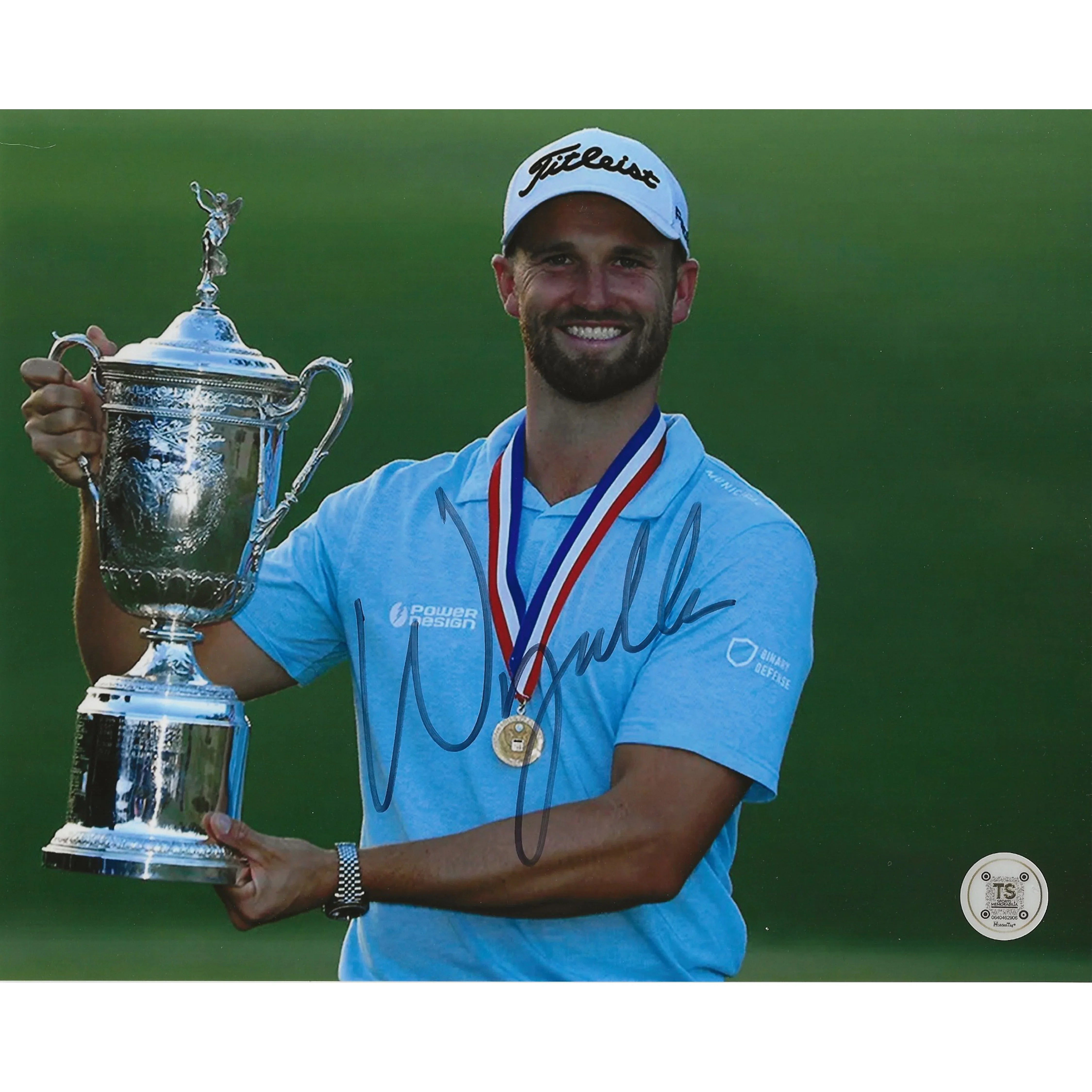 Golfer in blue shirt and Titleist cap holding trophy, medal around neck, signed photo
