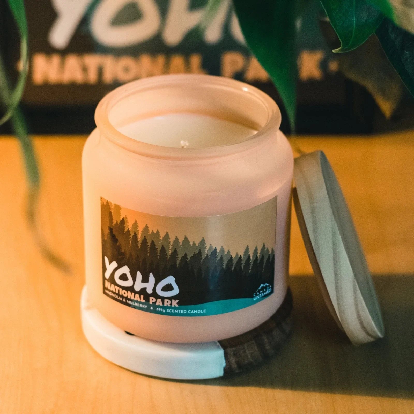Yoho National Park magnolia mulberry scented candle on wooden surface with lid beside jar