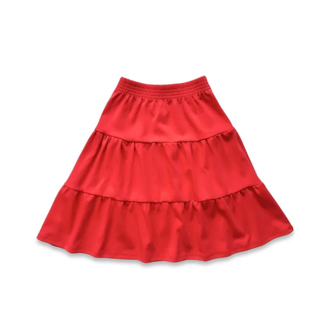 Red tiered ruffle skirt with elastic waistband on white background