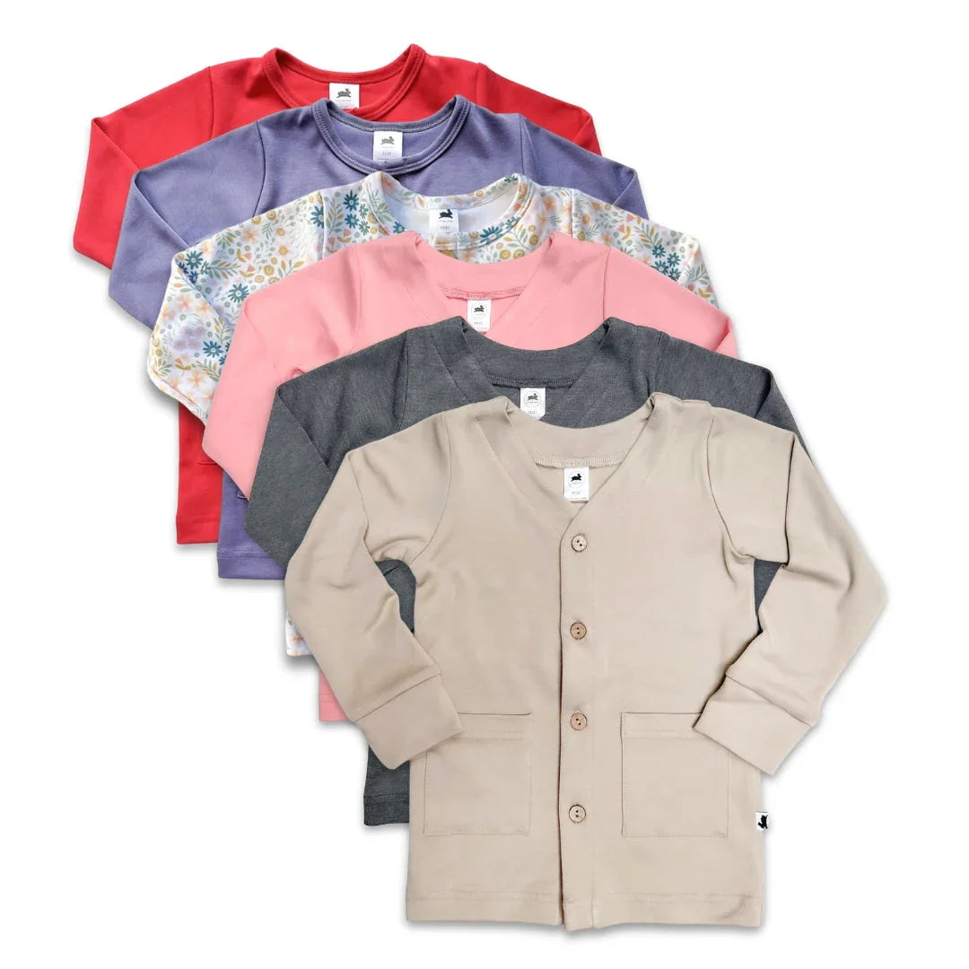 Assorted kids cardigans in beige, gray, pink, floral, purple, and red on white background