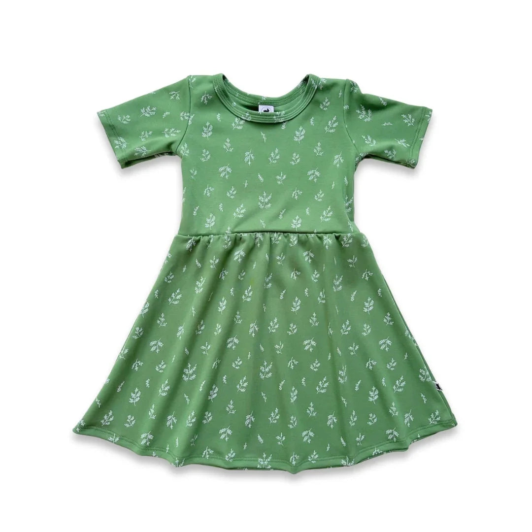 Green short-sleeve girls dress with white botanical print on white background
