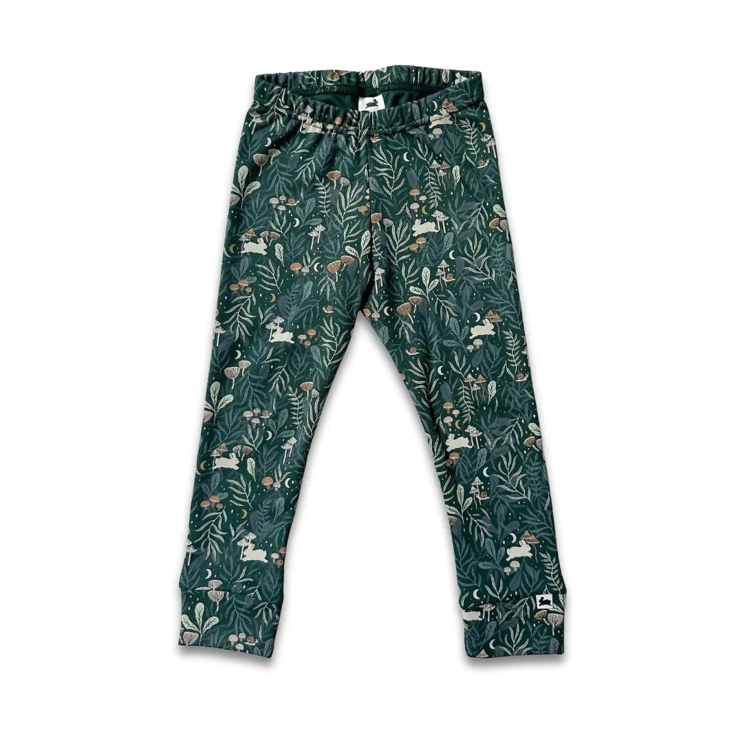 Green children's leggings with forest animals and botanical print on white background