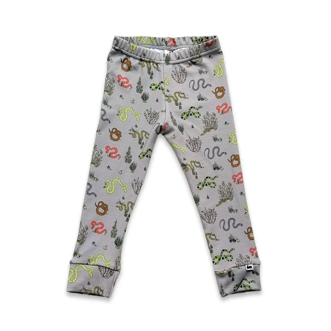 Youth bamboo leggings with colorful snake and plant print on light grey background