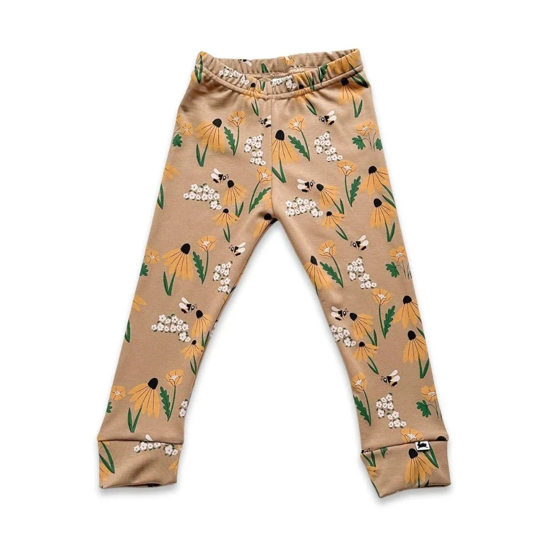 Youth bamboo leggings with yellow floral and bee print on a beige background