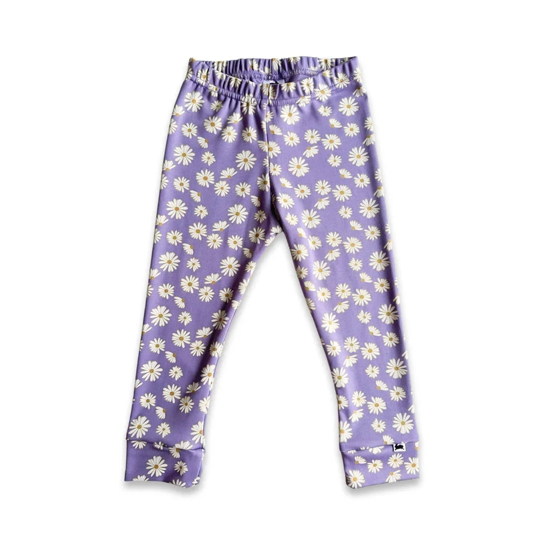 Purple kids leggings with white daisy floral print on plain background