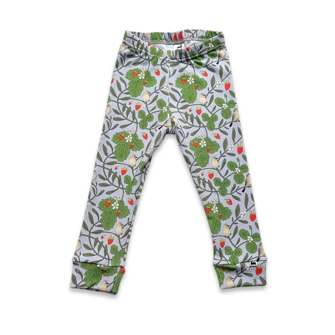 Youth bamboo leggings with green leaves, red berry, and bird print on a light background.