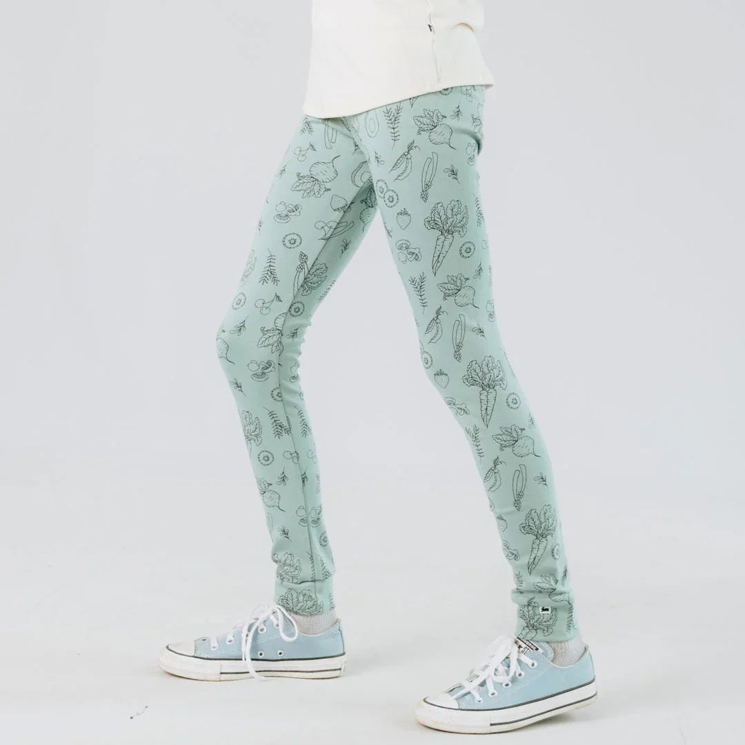 Youth bamboo leggings with botanical print, light green, worn with blue sneakers