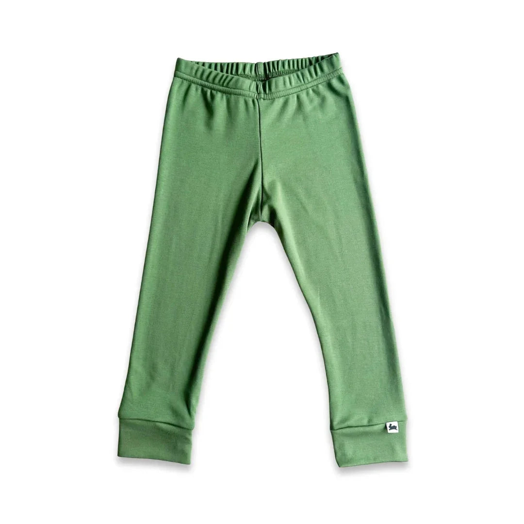 Green cotton baby leggings with elastic waistband on white background