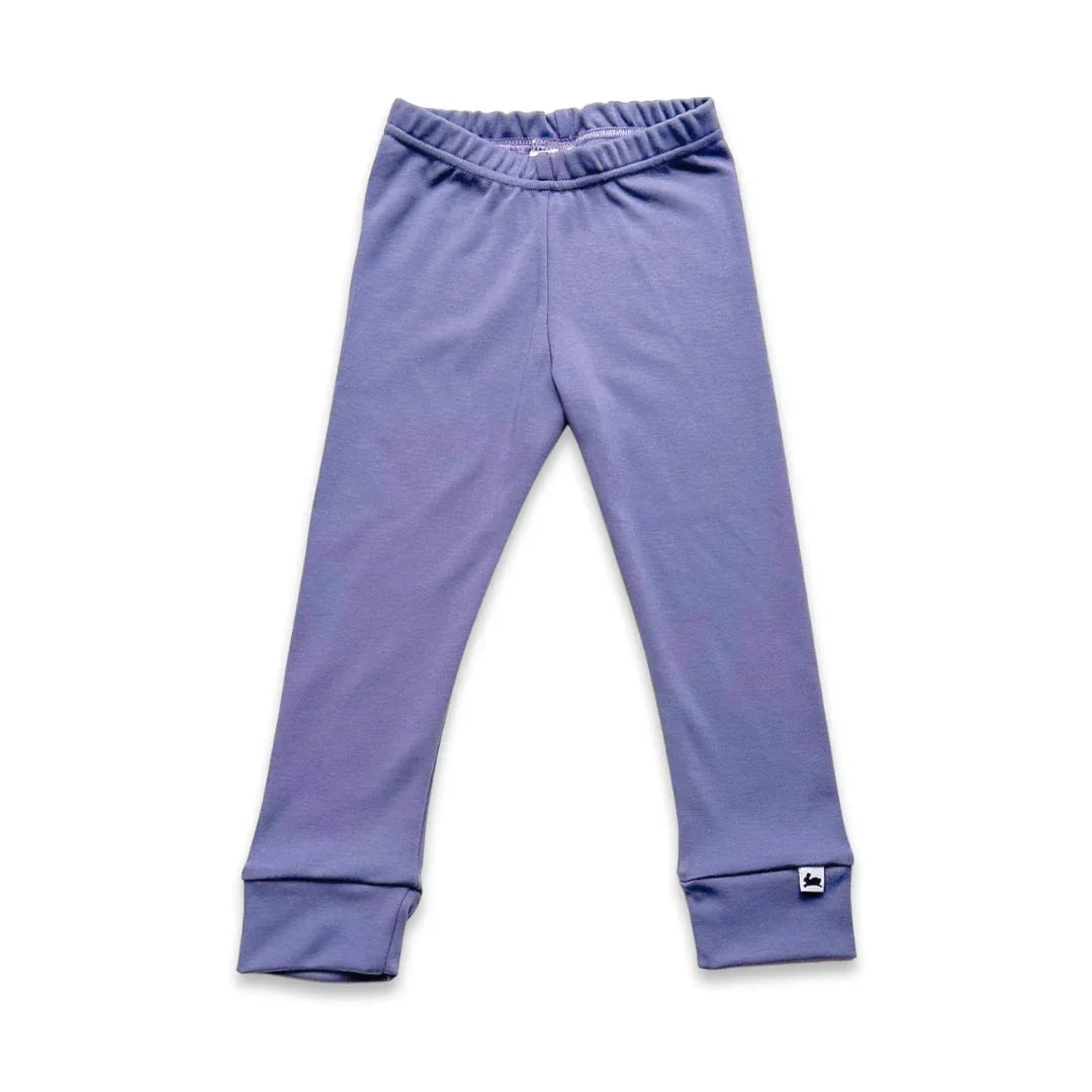 Purple kids leggings with elastic waistband and cuffed ankles on white background