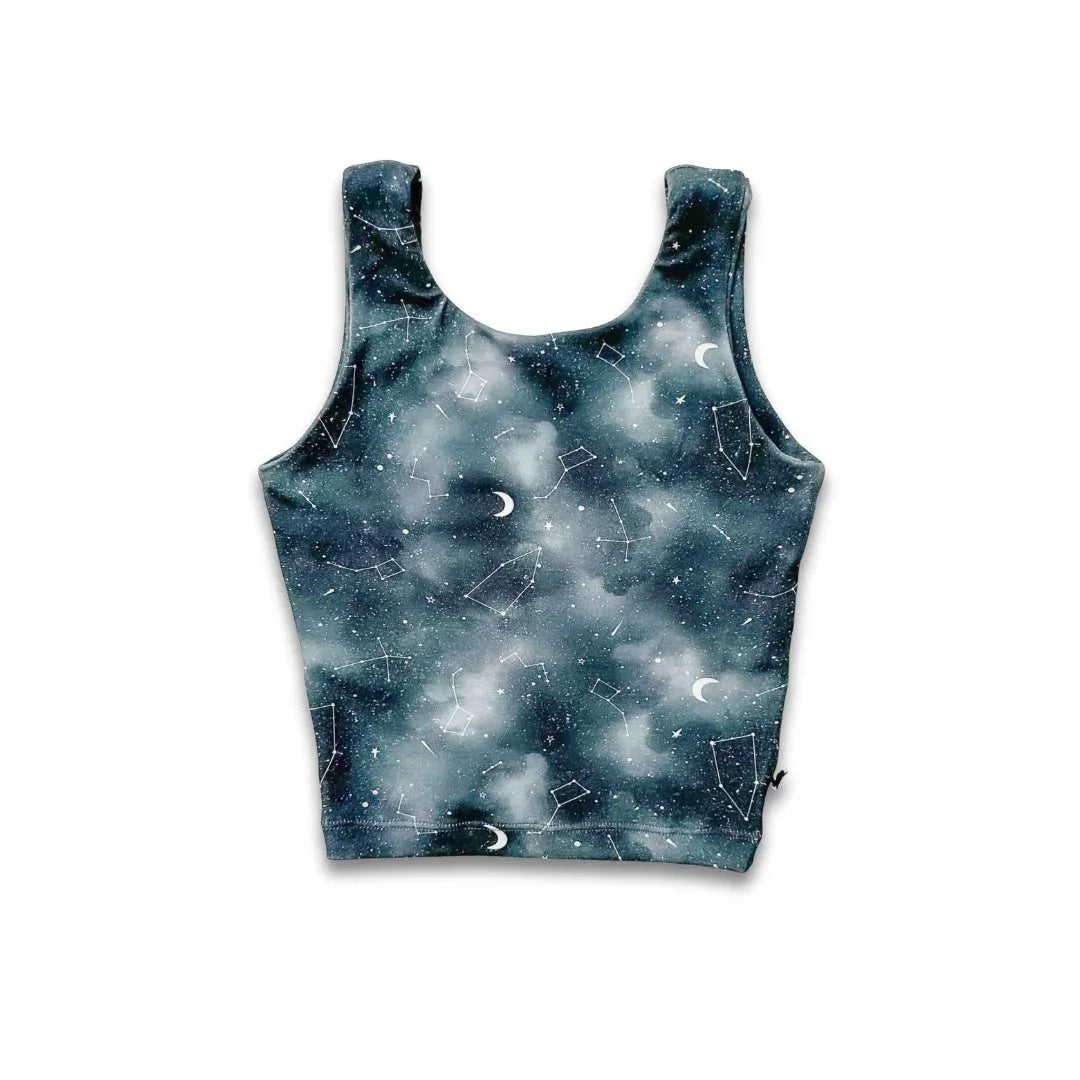 Celestial print crop tank top with stars, constellations, and moons on a dark galaxy background