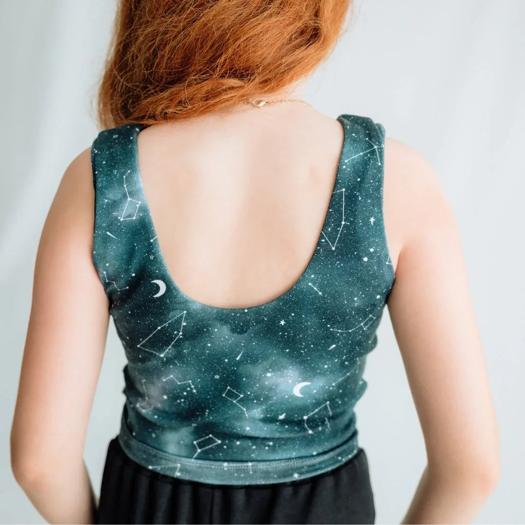 Woman wearing galaxy constellation print crop top with scoop back