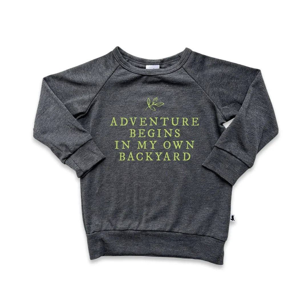 Gray sweatshirt with 'Adventure begins in my own backyard' text and leaf graphic