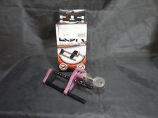 Acu-Loc archery safety bow lock with key and packaging on a dark surface.