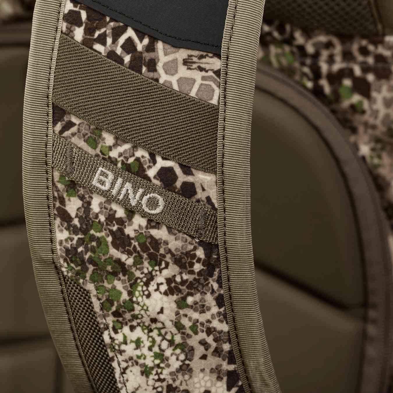 Close-up of Badlands 2200 backpack camo strap with 'BINO' label, outdoor gear
