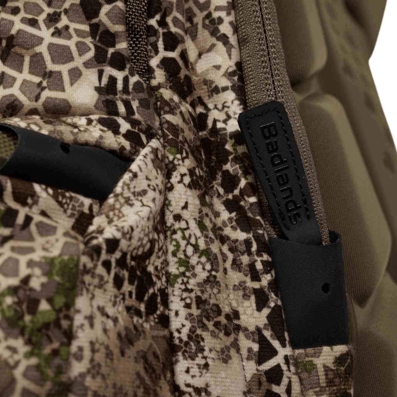 Close-up of Badlands camo backpack with hexagonal pattern and branded black tag