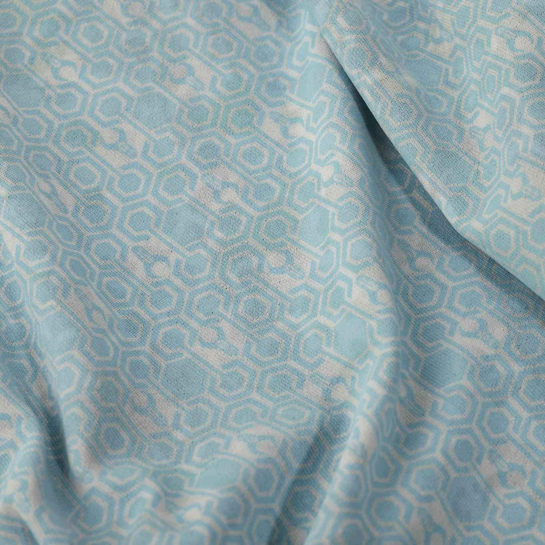 Light blue neck gaiter fabric with geometric hexagon pattern, close-up texture view