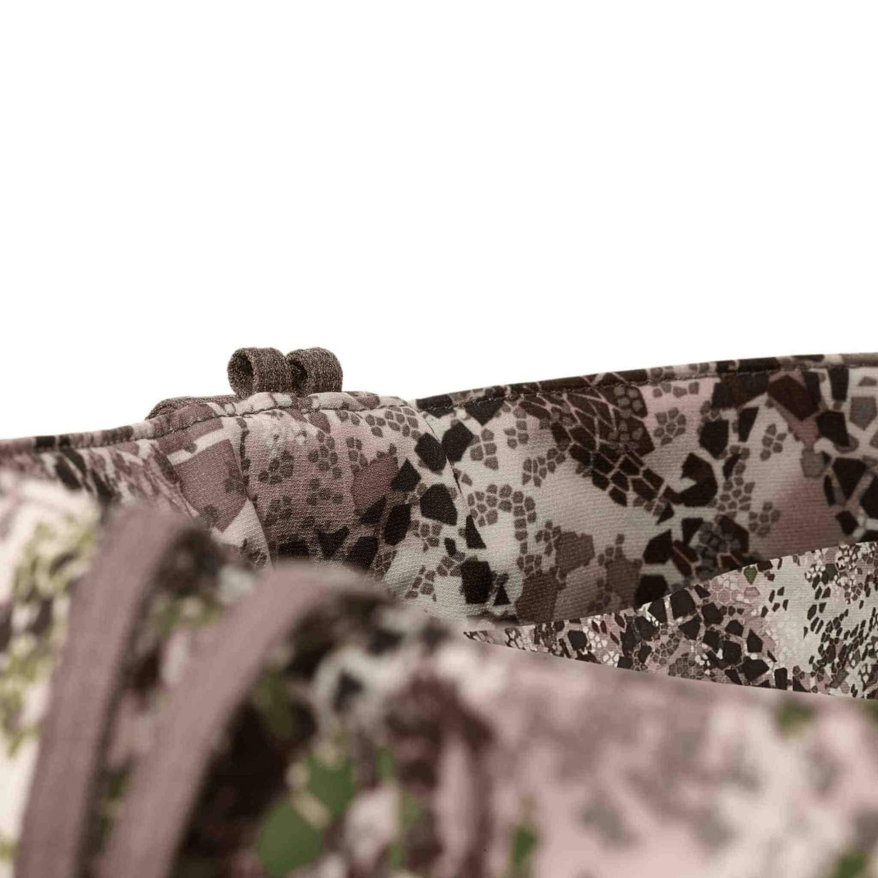 Close-up of Badlands Algus Pant waistband with multicolor camo pattern fabric detail