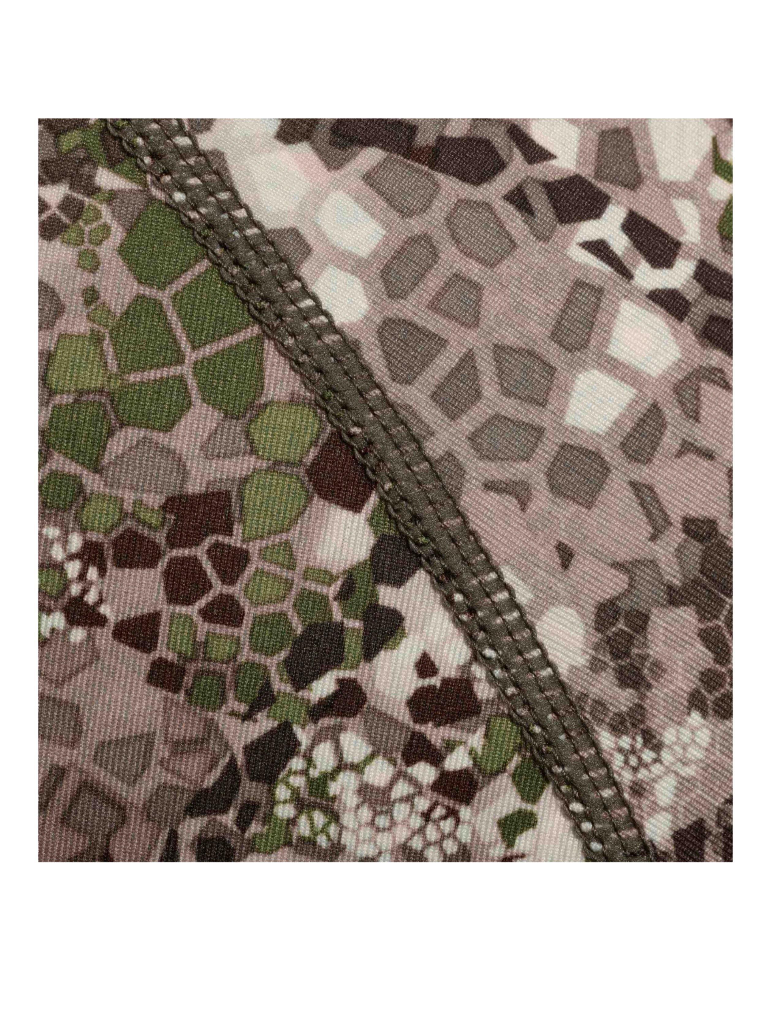 Close-up of Badlands Algus camo fabric with detailed stitching and hexagon camouflage pattern
