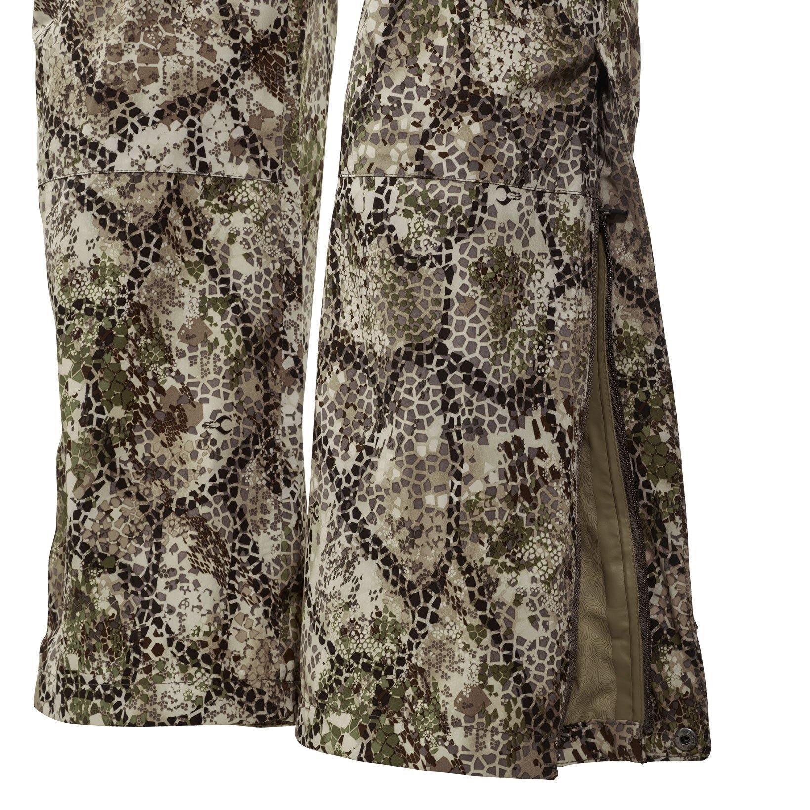 Close-up of Badlands Bail rain pants with green and brown camouflage and side zipper