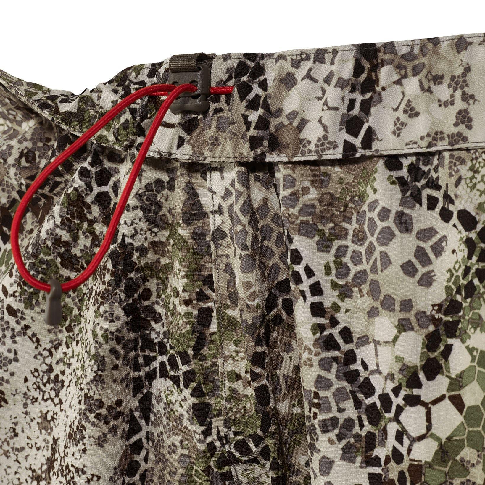 Close-up of Badlands camo rain pants with adjustable red drawstring waist