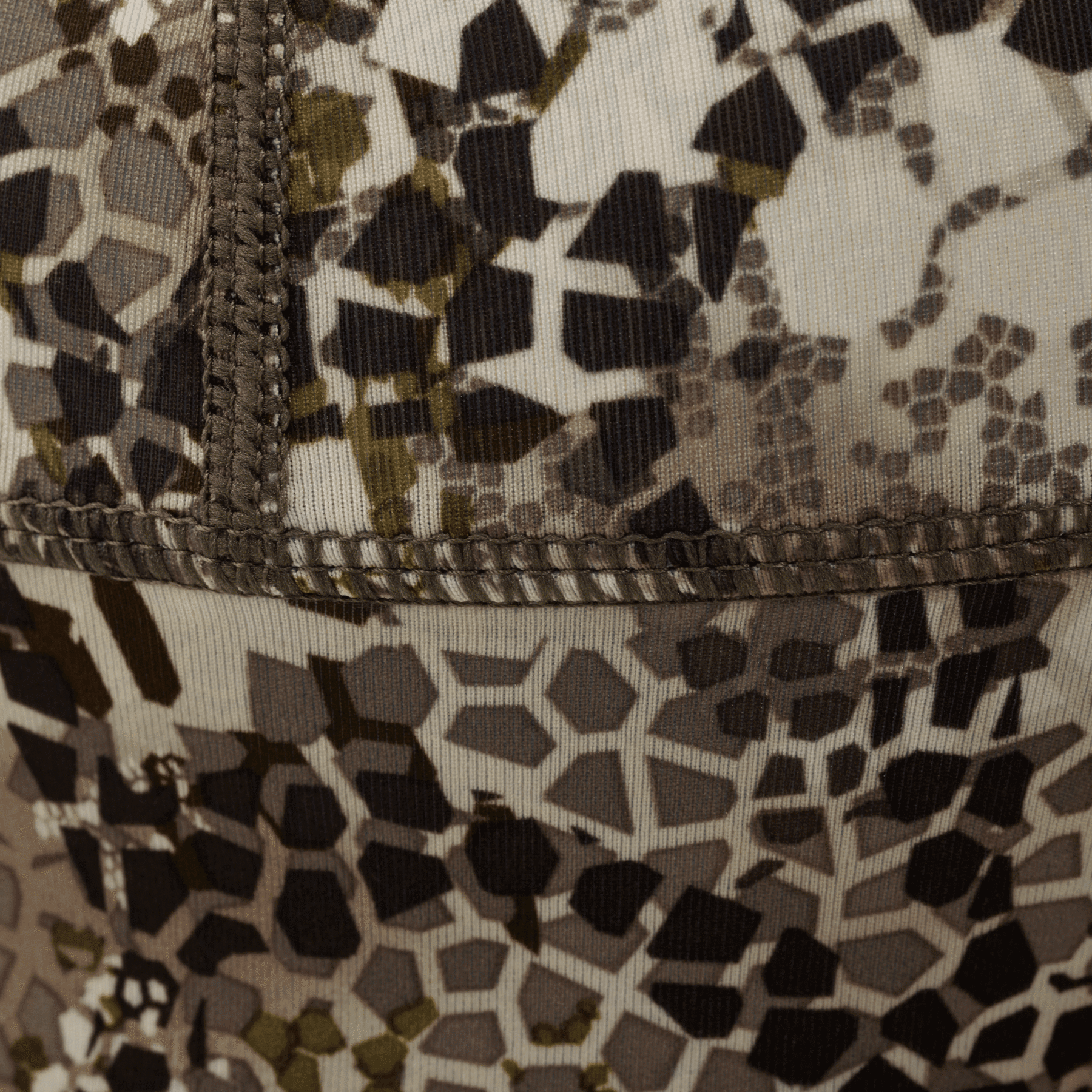 Close-up of Badlands Calor beanie with brown and beige geometric camo pattern, visible stitching