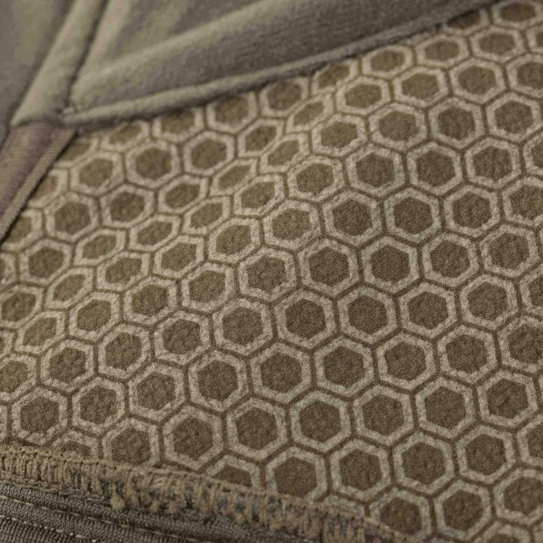 Close-up of Badlands Calor Jacket with hexagonal pattern in olive green fabric