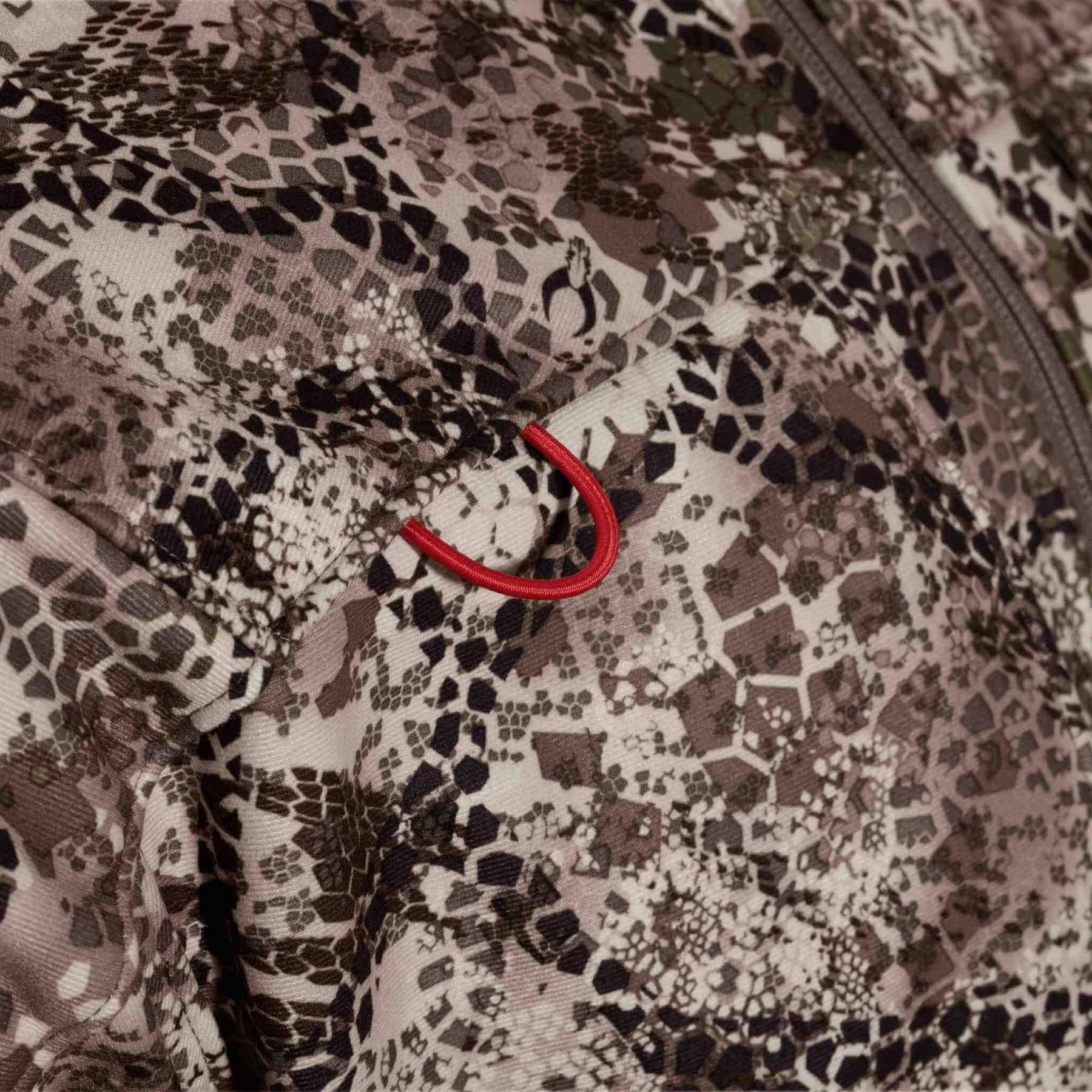 Close-up of Badlands Calor Jacket with camo pattern and red zipper pull