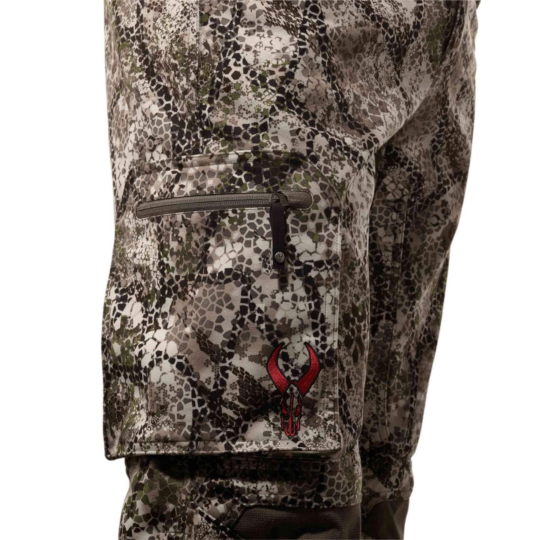 Badlands Calor Pant with camo pattern and red logo, closeup of thigh zip pocket