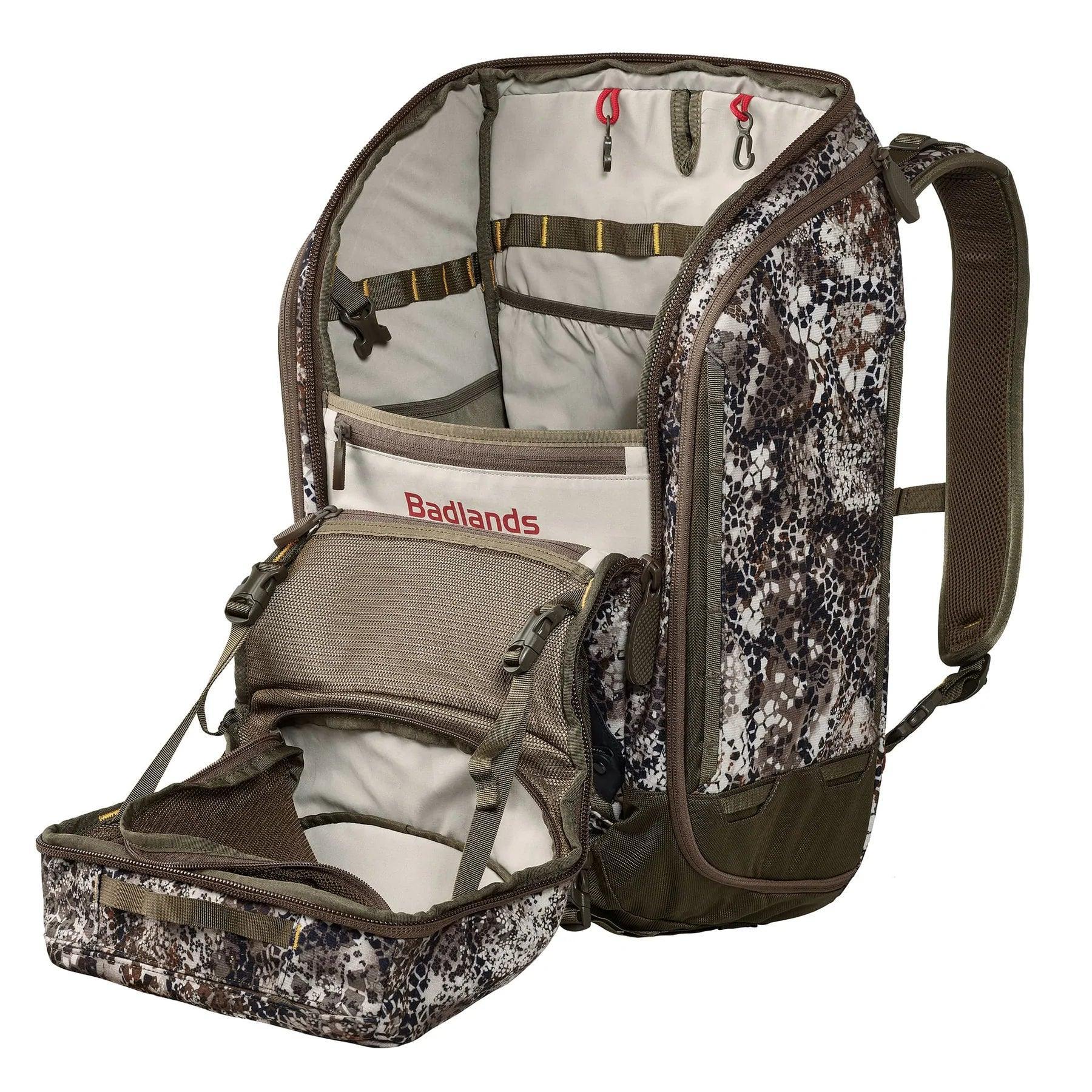 Badlands Connect camo backpack open, showing multiple compartments and outdoor gear storage