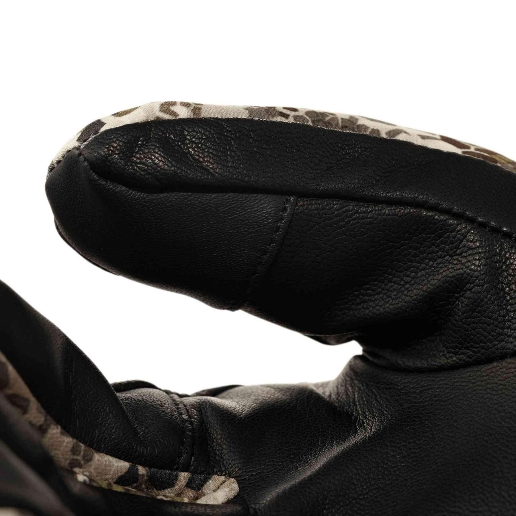 Close-up of black leather Badlands Convection Glove with camo trim detail