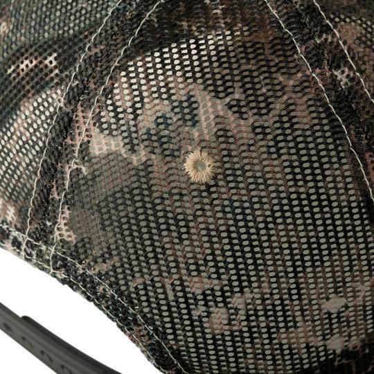 Close-up of camo mesh Badlands hat with adjustable snapback, outdoor cap detail
