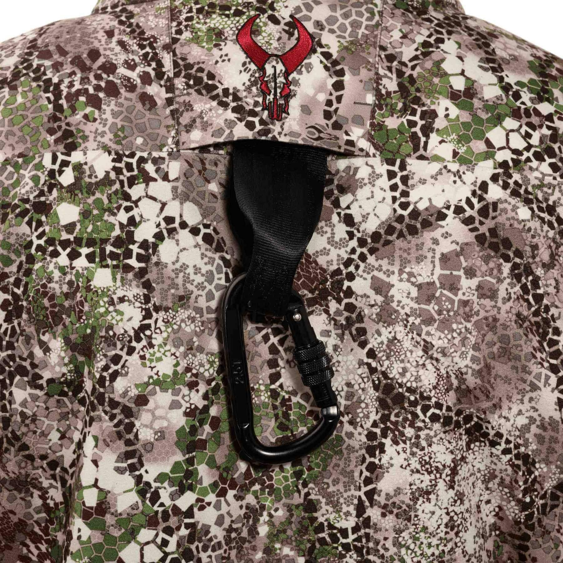 Badlands Pyre camo jacket back detail with red horn logo and black carabiner clip