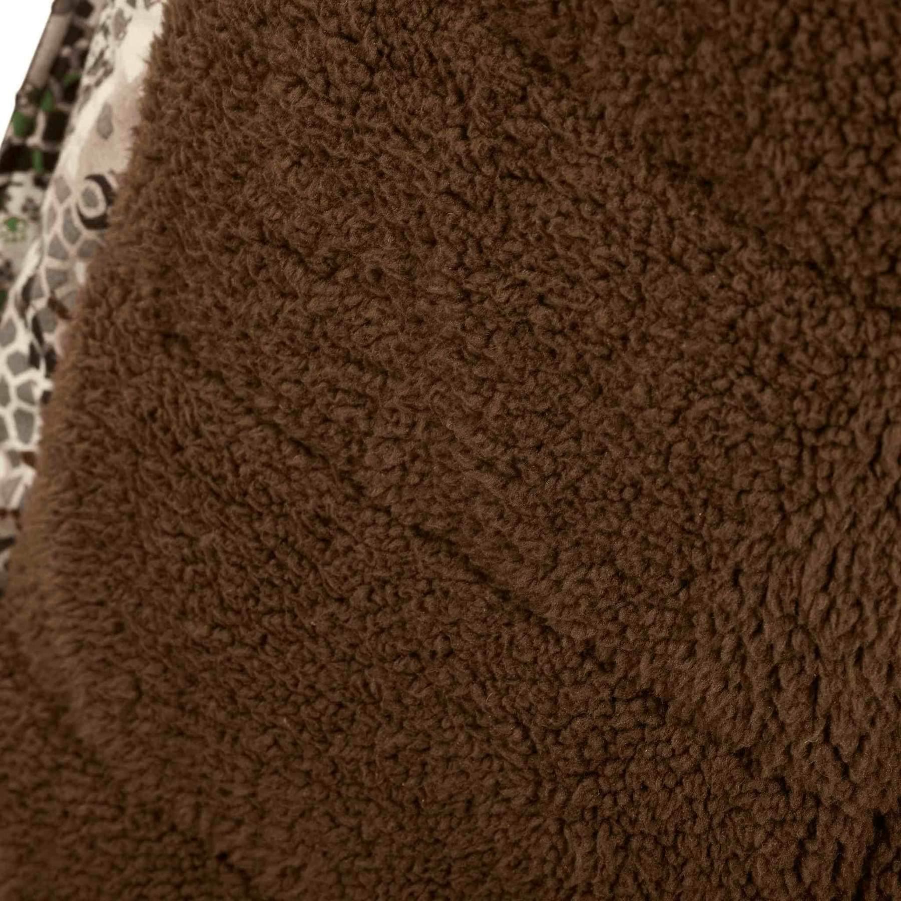 Close up of brown fleece fabric with partial camouflage pattern, outdoor jacket detail
